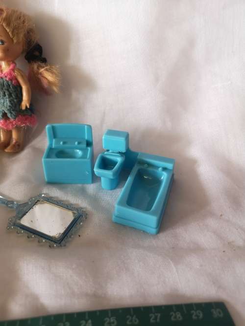 Two small Barbie's sister-like dolls with toy furniture.