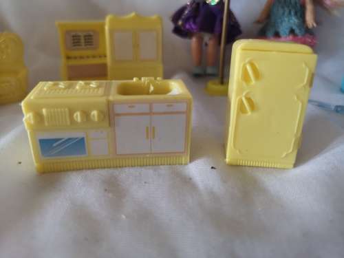 Two small Barbie's sister-like dolls with toy furniture.