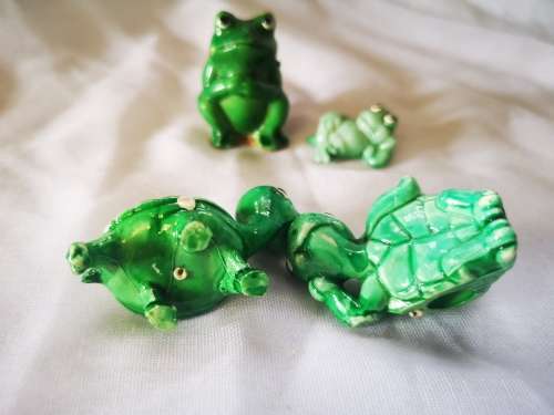Lot of green ornaments - frogs and tortoises