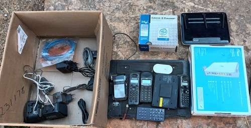 Box of electronics 2xRouters, wireless phones, hand cam,  CPU, cooling pad wires and so on