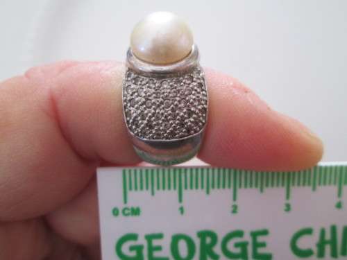 VERY PRETTY STERLING SILVER RING WITH PEARL AND DIAMONDS OR CUBICSECONIA NOT SURE