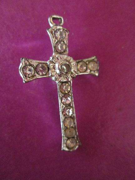Silver coloured cross with Lords prayer in center