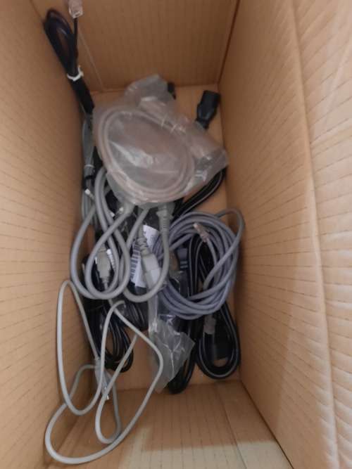 Box of computer cables and programme discs