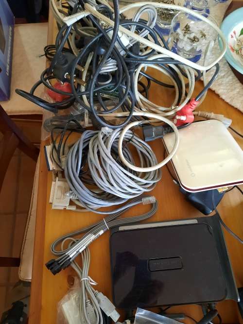 Box of computer cables and programme discs
