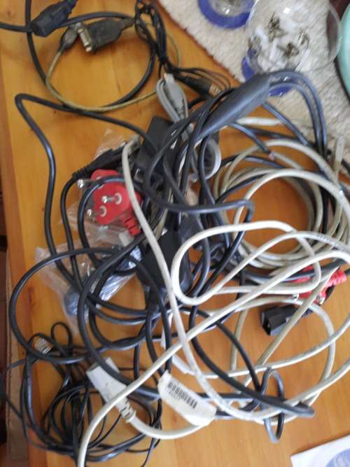 Box of computer cables and programme discs