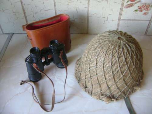OLD BINOCULARS AND ARMY HELMUT IN GOOD CONDITION