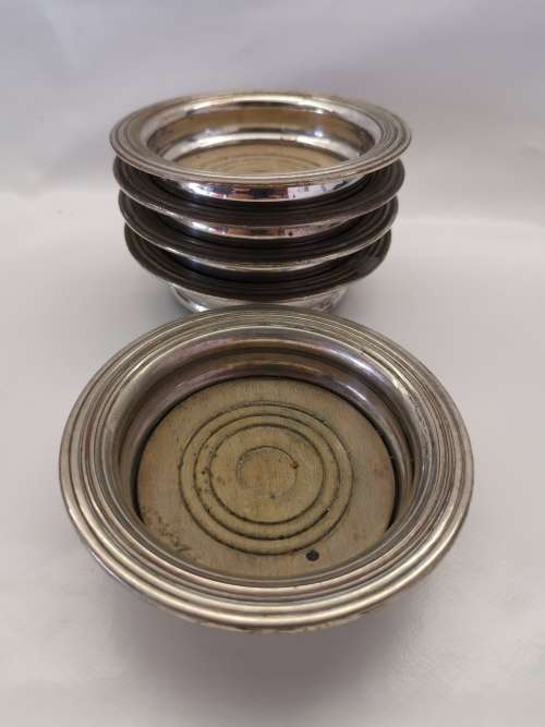 FIVE VICTORIAN SILVERPLATE BOTTLE COASTERS