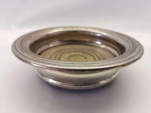FIVE VICTORIAN SILVERPLATE BOTTLE COASTERS