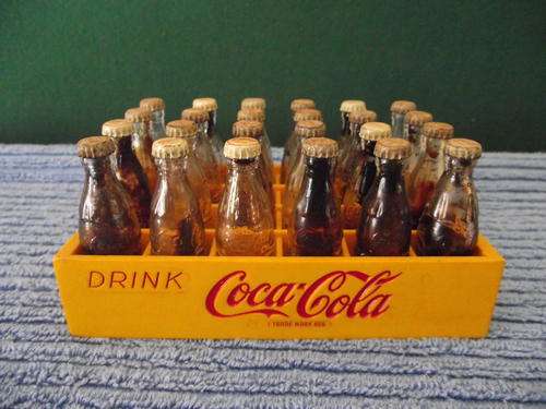 plastic coca cola crate with 24 miniature glass bottles