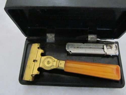 A Vintage  Schick Injector Razor With Butterscotch Bakelite Handle