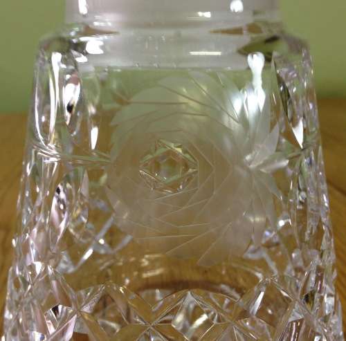 DECANTER=CUT GLASS DECANTER=TAPERED ROUND=EXCELLENT CONDITION=ROSE PATTERN ENGRAVING.