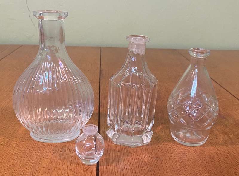 GLASS VASES / BOTTLES x 4 - possibly perfume bottles without stoppers.