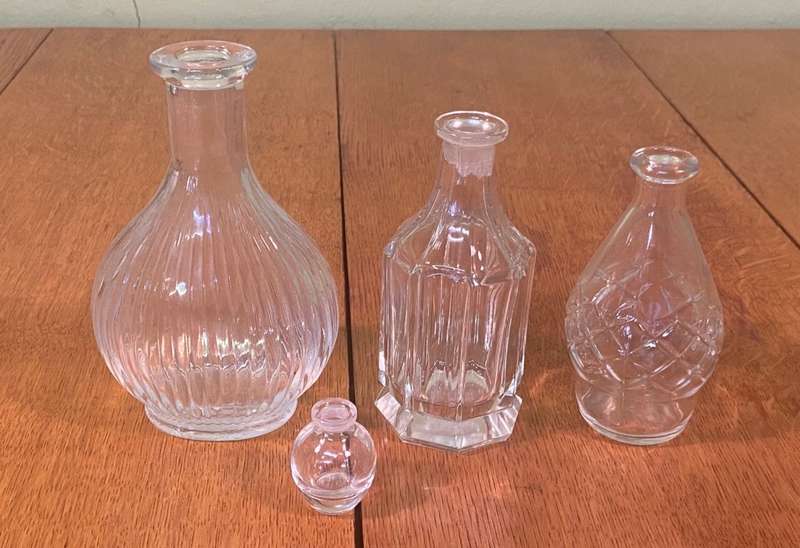 GLASS VASES / BOTTLES x 4 - possibly perfume bottles without stoppers.