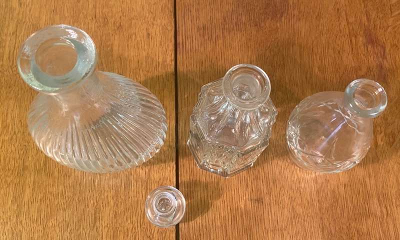 GLASS VASES / BOTTLES x 4 - possibly perfume bottles without stoppers.