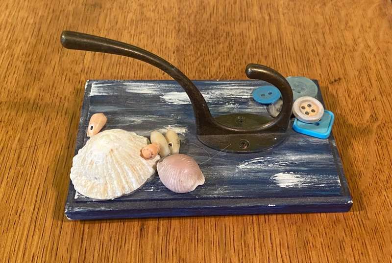 COAT / HAT WALL HOOKS on SMALL PAINTED PANEL with SHELLS & BUTTONS.