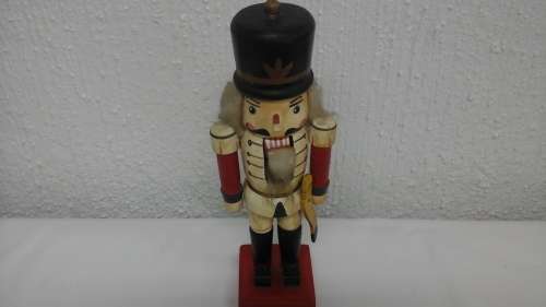 HERE WE HAVE A VERY REGAL WOODEN NUTCRACKER SOLDIER CHRISTMAS ORNAMENT.