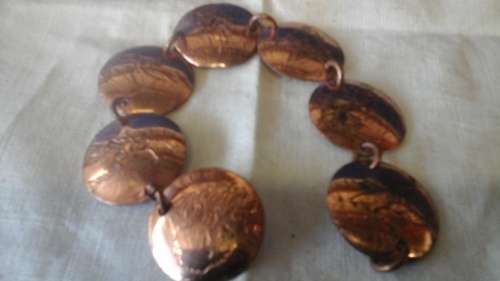 UNIQUE AND INTERESTING. A COPPER BRACELET MADE OF PRESSED DISCS OF COPPER JOINED WITH LINKS