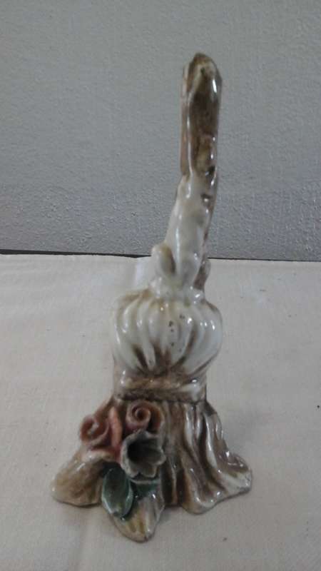 A CUTE AND COLLECTIBLE CERAMIC WITCHES BROOM. WITH FLOWERS ON THE BRISTLES. VERY UNUSUAL