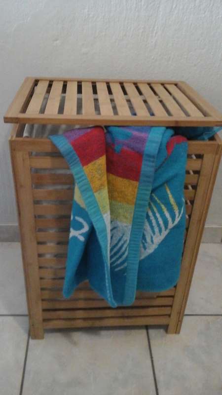 A CLASSY RECTANGULAR BAMBOO LINEN BASKET. HAS A MATERIAL LINER. MARKETED BY WOOLWORTHS