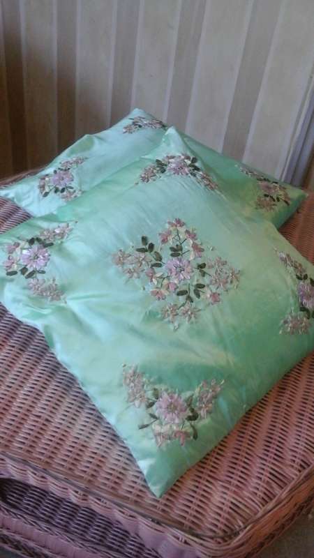 TWO DAINTY GREEN SATIN SCATTER CUSHIONS WITH RIBBON TRIM