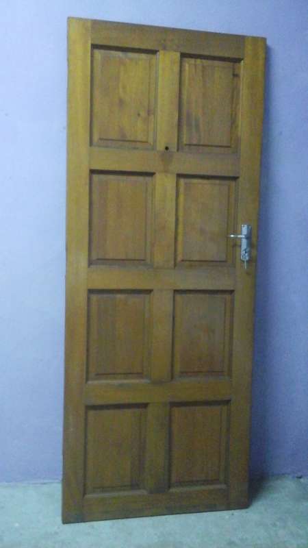 AN AWESOME 8 PANEL WOODEN DOOR. STILL HAS THE LOCK AND KEY JUST NEEDS THE PEEPHOLE AND HINGES