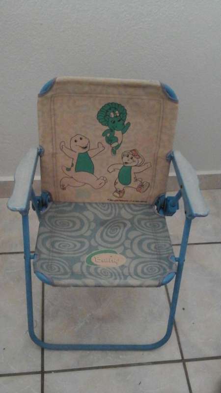 WELL LOVED AND FADED WITH AGE HIGHLY COLLECTIBLE A BARNEY KIDDIES FOLD UP CHAIR.