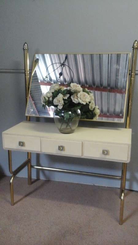 WOW A MAGNIFICENT POSSIBLY BRASS AND WOOD DRESSING TABLE. HAS A MIRROR AND THREE DRAWERS