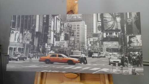 A MAGNIFICENT CANVAS PRINT OF A CITY SCENE WITH A TAXIS DRIVING IN THE STREET
