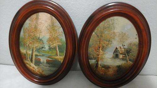 TWO STUNNING WOOD FRAMED OVAL OIL PAINTINGS OF A RIVER AND TREES. ONE HAS A HOUSE IN IT