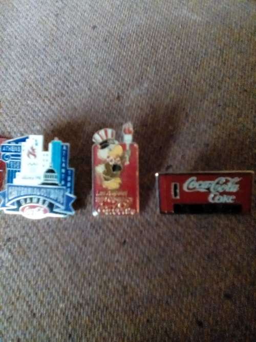 THREE COLLECTOR'S COCA-COLA METAL BADGES