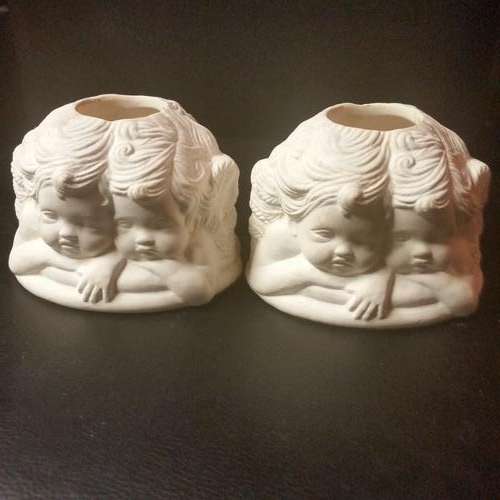 TWO UNPAINTED CERAMIC ITEM WITH FOUR ANGELS AROUND EACH ITEM
