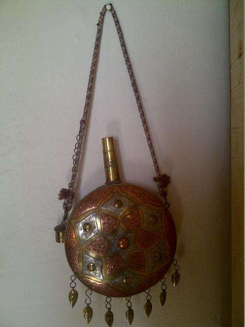 A BEAUTIFUL ORNATE MOROCCAN COPPER AND BRASS WATER CARRIER