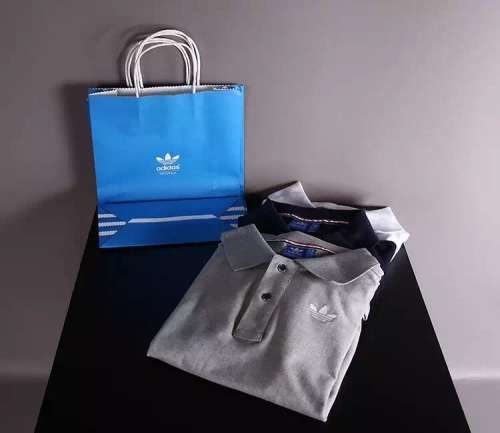 The brand with 3 stripes Adidas two button golfer T-Shirt.