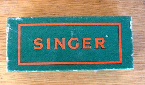 SINGER BOX WIH SOME TOOLS IN IT