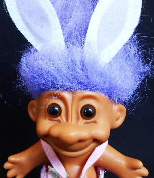 collectable Troll doll in baby suit with bunny ears