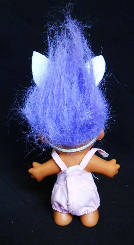 collectable Troll doll in baby suit with bunny ears