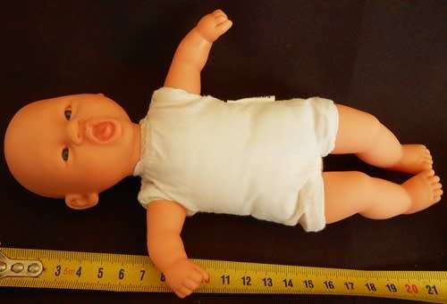 Small soft bodied doll Gi Go Toys with yawning face.