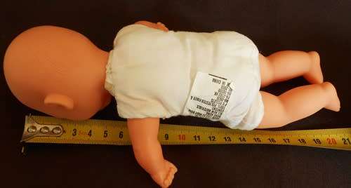 Small soft bodied doll Gi Go Toys with yawning face.