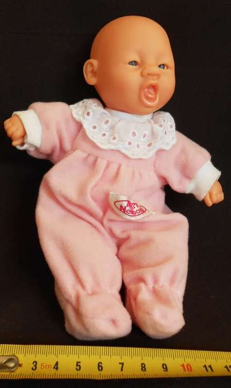 Small soft bodied doll Gi Go Toys with yawning face.