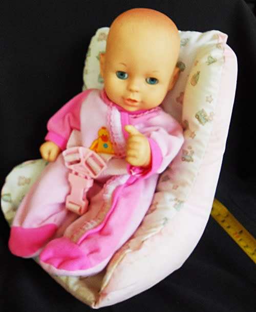 Cititoy hard plastic and vinyl doll in baby seat