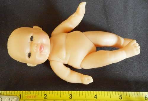 Small chubby baby doll looks like Berenguer doll with cute smile brown eyes