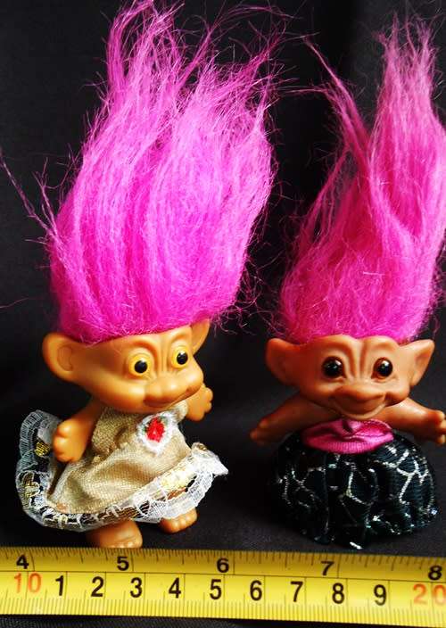 Two small Collectable Troll dolls with pink hair dressed in party dresses