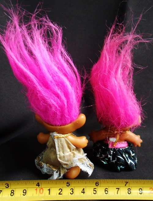 Two small Collectable Troll dolls with pink hair dressed in party dresses