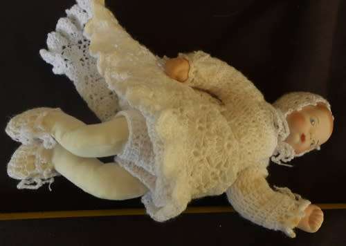 collectable handmade porcelain baby doll in fine crotchet dress