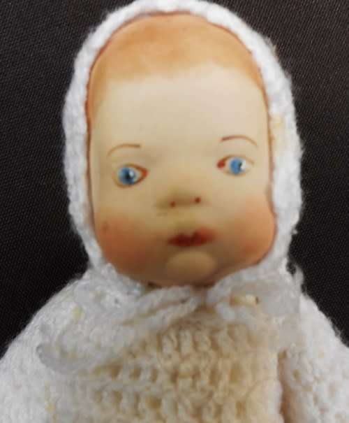 collectable handmade porcelain baby doll in fine crotchet dress