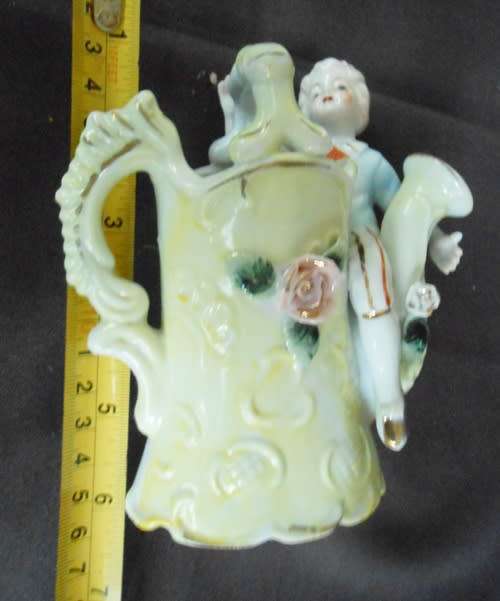 Porcelain vase in shape of watering can with figure and decoration.Retro kitsch