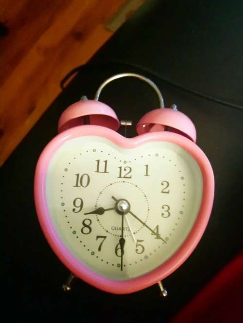small pink alarm clock working