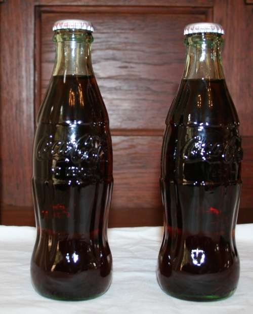 TWO COLLECTABLE 250ML COKE BOTTELS THATS NO LONGER AVAILABLE IN RETAIL COLLECTABLE ITEM!!