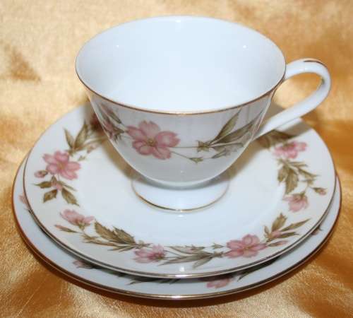 FOUR EXQUISITE VINTAGE PORCELAIN TRIO SETS BEAUTIFULLY DESIGNED WITH A FLORAL  PATERN -