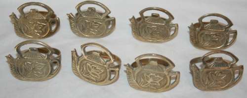 WOW A RARE COLLECTION OF BRASS SERVIETTE RINGS DECORATED WITH A BRASS KETTLE ON TOP STUNNING!!!
